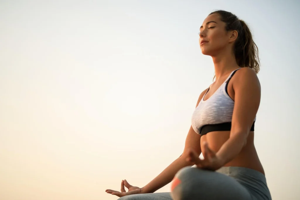 A woman meditates to maintain her health and longevity